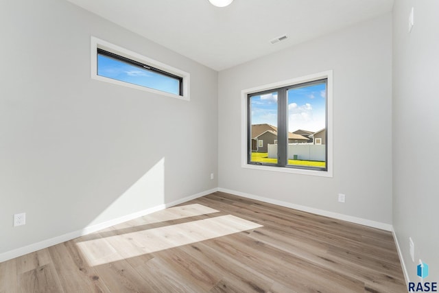 unfurnished room with light wood-type flooring