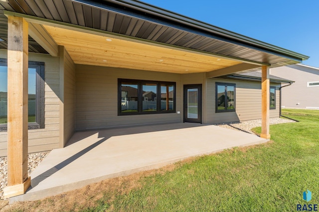 rear view of house with a patio area and a lawn