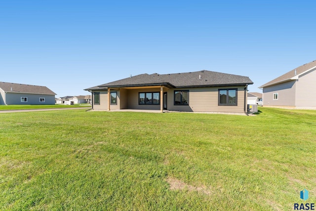 rear view of house with a yard, central AC, and a patio