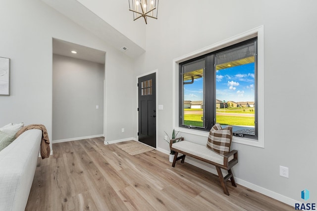 entryway featuring a notable chandelier and light hardwood / wood-style floors