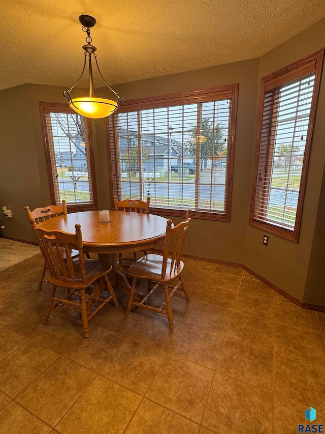 unfurnished dining area featuring tile patterned floors and a textured ceiling