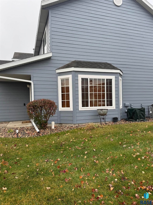 view of side of home featuring a lawn