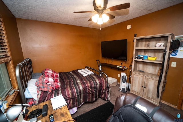 carpeted bedroom with a textured ceiling and a ceiling fan