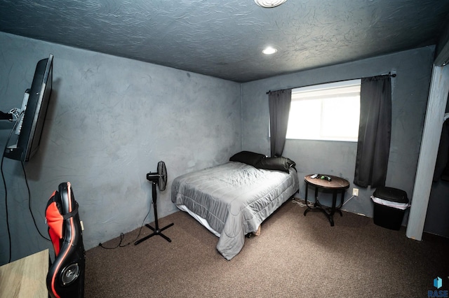 carpeted bedroom with a textured ceiling