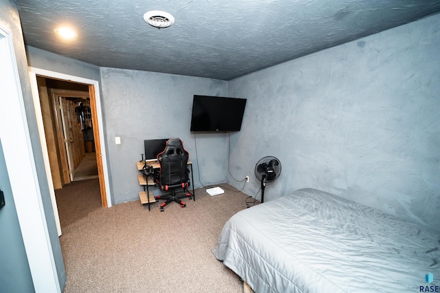 carpeted bedroom with visible vents and a textured ceiling