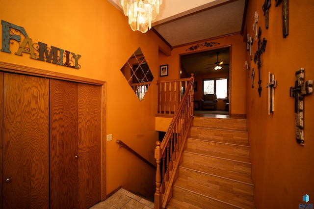 staircase with an inviting chandelier