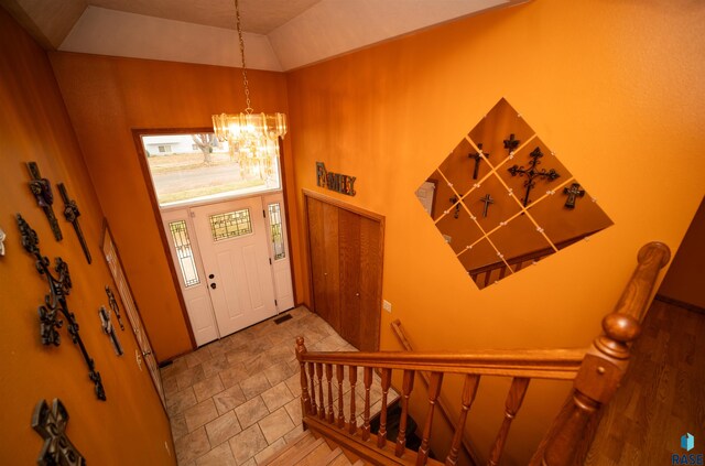 foyer with stairs, a towering ceiling, and a chandelier