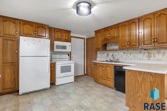 kitchen with a textured ceiling, white appliances, and sink