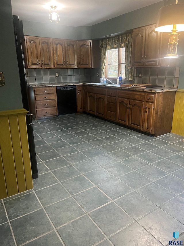 kitchen featuring decorative backsplash and black dishwasher