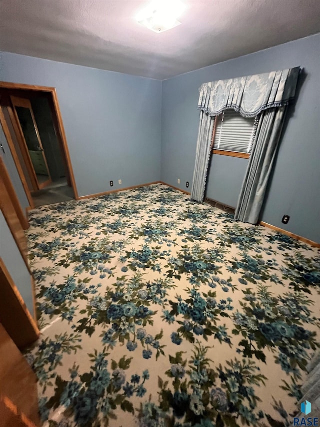 bedroom with carpet flooring and a textured ceiling