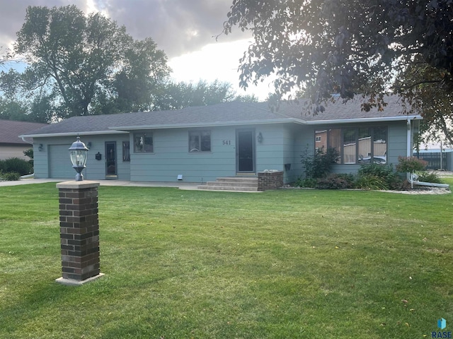 view of front of home with a front lawn and a garage