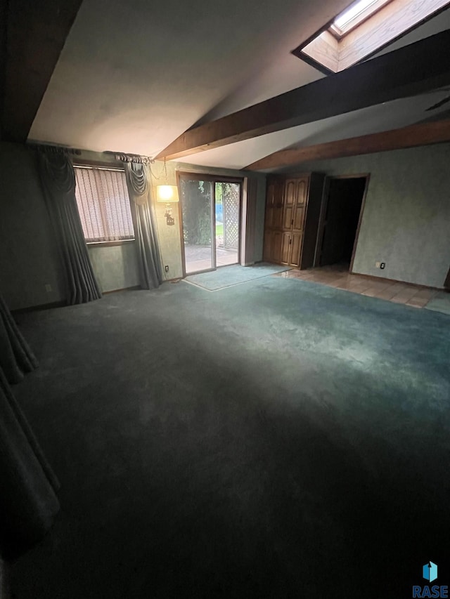 carpeted spare room with lofted ceiling with skylight