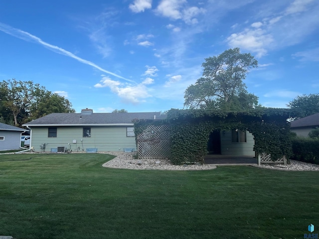 back of house featuring a patio, central AC, and a lawn