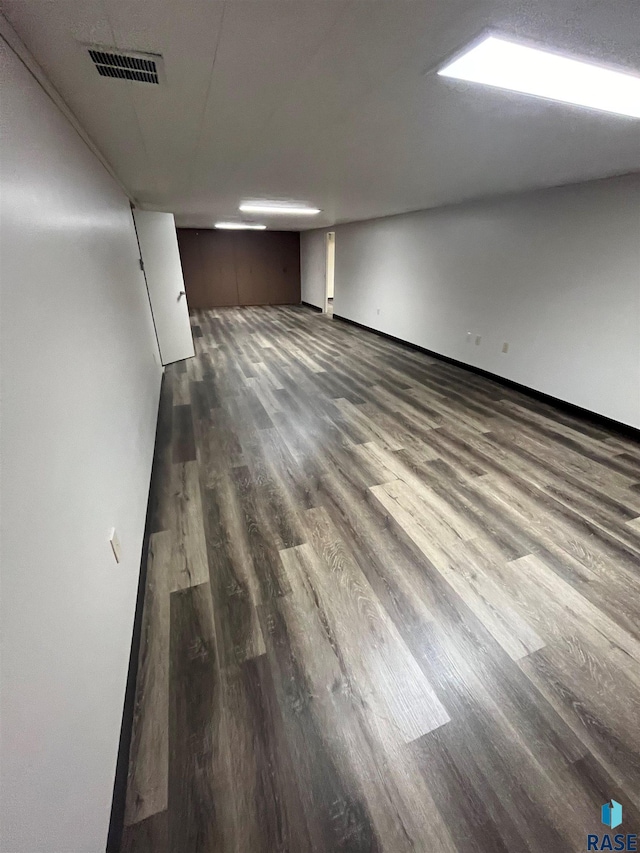 unfurnished room with dark hardwood / wood-style floors