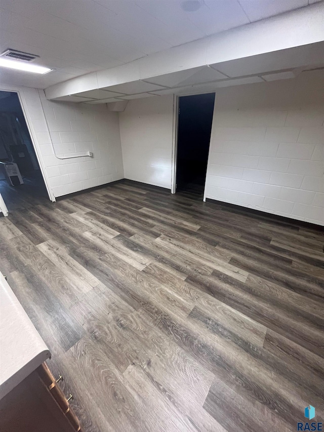 basement with dark hardwood / wood-style flooring