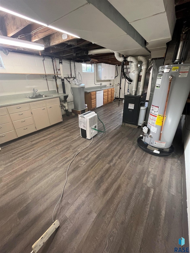 basement featuring dark wood-type flooring, water heater, heating unit, and sink