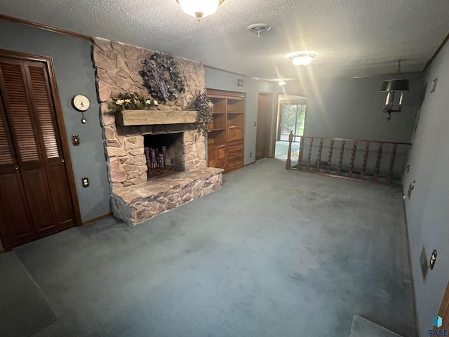 unfurnished living room featuring a stone fireplace, a textured ceiling, and carpet floors