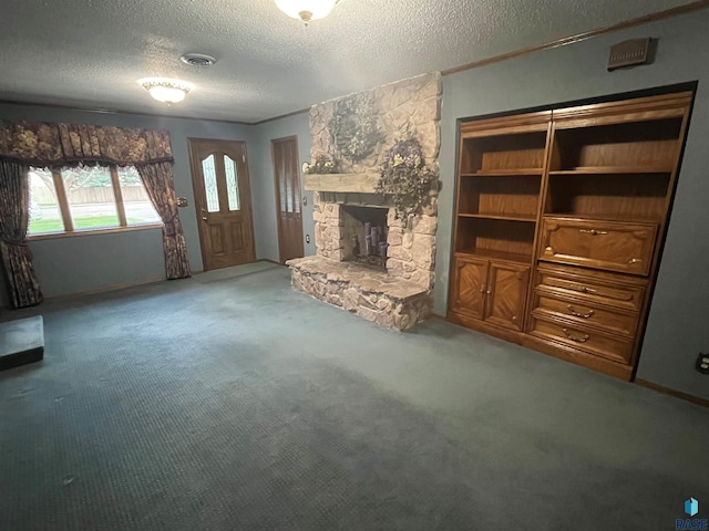 unfurnished living room featuring a stone fireplace, a textured ceiling, and carpet