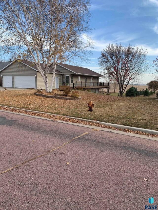 ranch-style home with a garage and a front yard