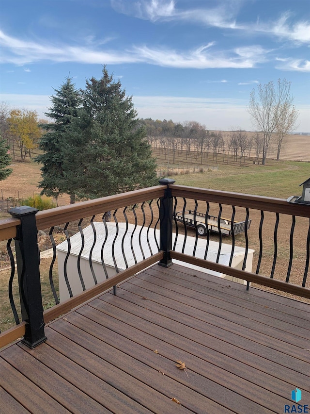 wooden deck featuring a rural view