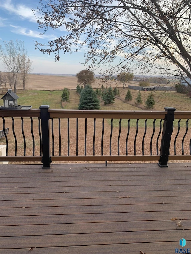 wooden terrace featuring a rural view