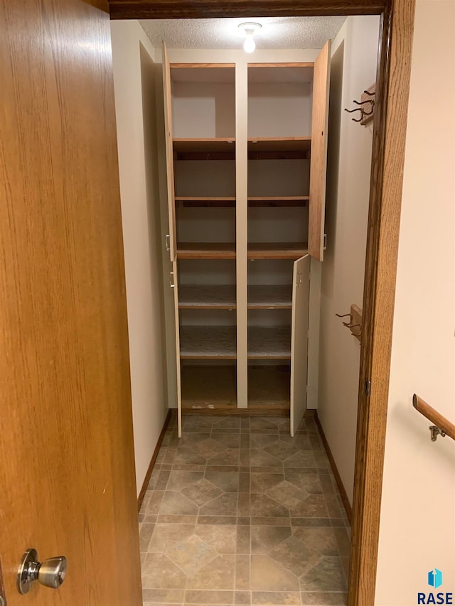 spacious closet with tile patterned floors