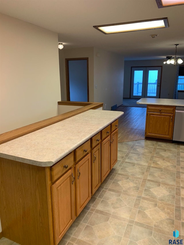 kitchen featuring french doors, a kitchen island, a notable chandelier, light hardwood / wood-style floors, and dishwasher