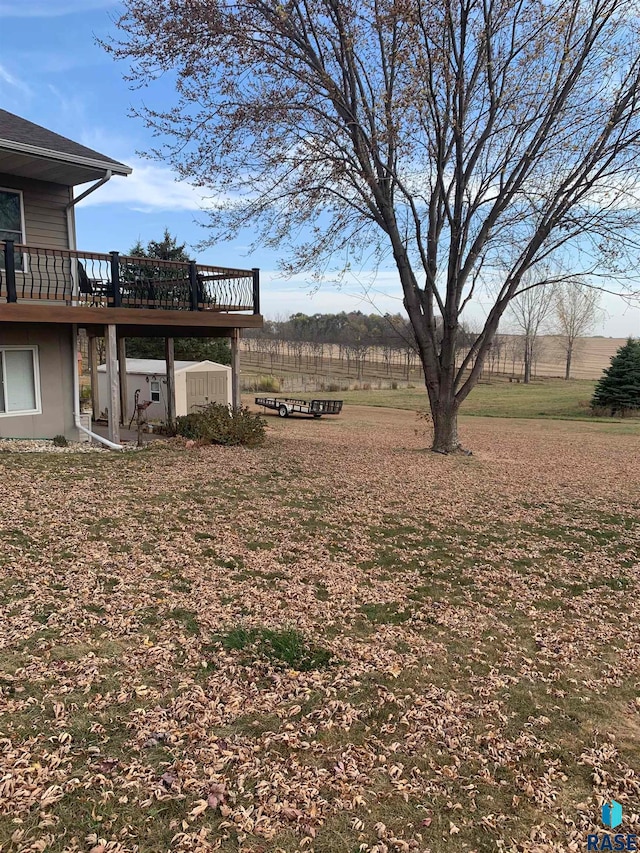 view of yard featuring a rural view and a deck