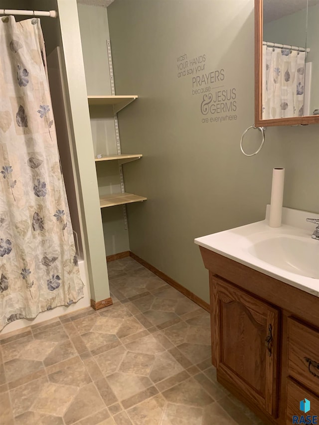 bathroom featuring vanity and shower / bathtub combination with curtain