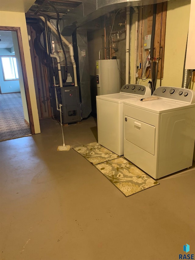 basement with heating unit, gas water heater, and washer and dryer