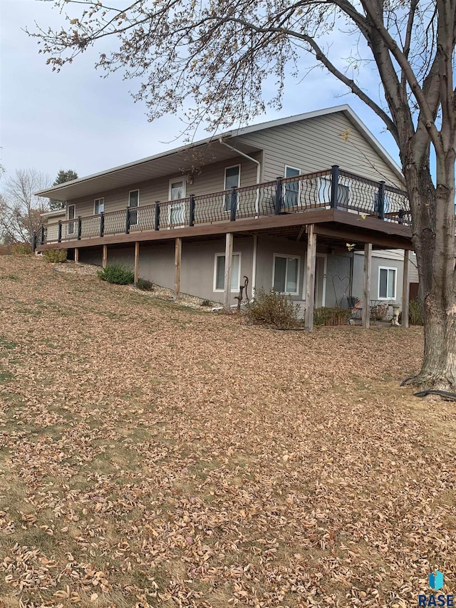 rear view of house featuring a deck