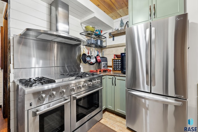 kitchen with green cabinets, light hardwood / wood-style flooring, stainless steel appliances, and ventilation hood