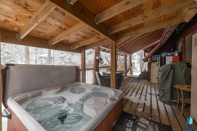 snow covered deck with a hot tub