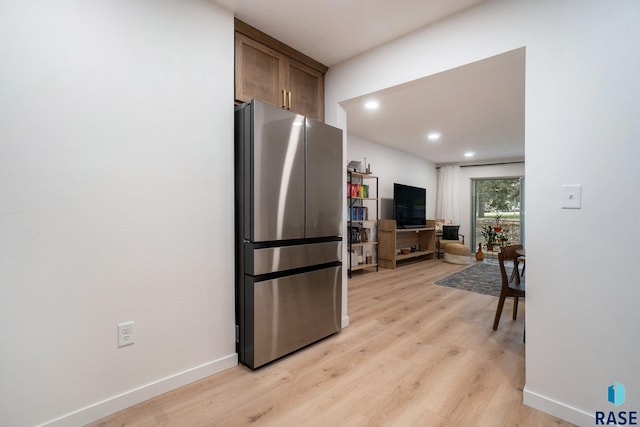 kitchen featuring light hardwood / wood-style flooring and stainless steel refrigerator