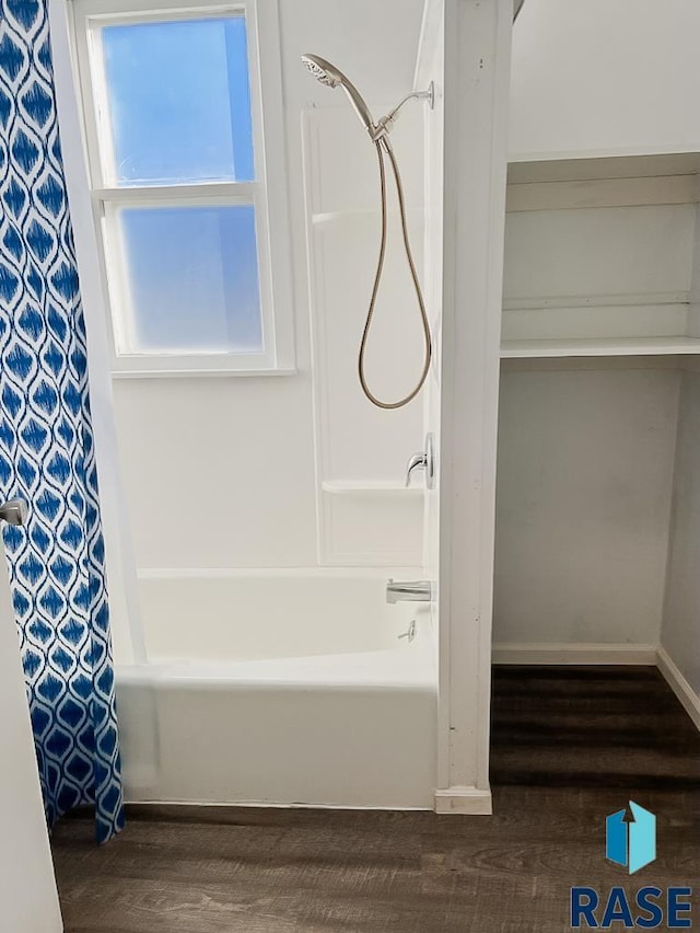 323 W Lincoln St, Luverne, MN 56156 - bathroom with wood finished floors, shower / tub combo with curtain, and baseboards
