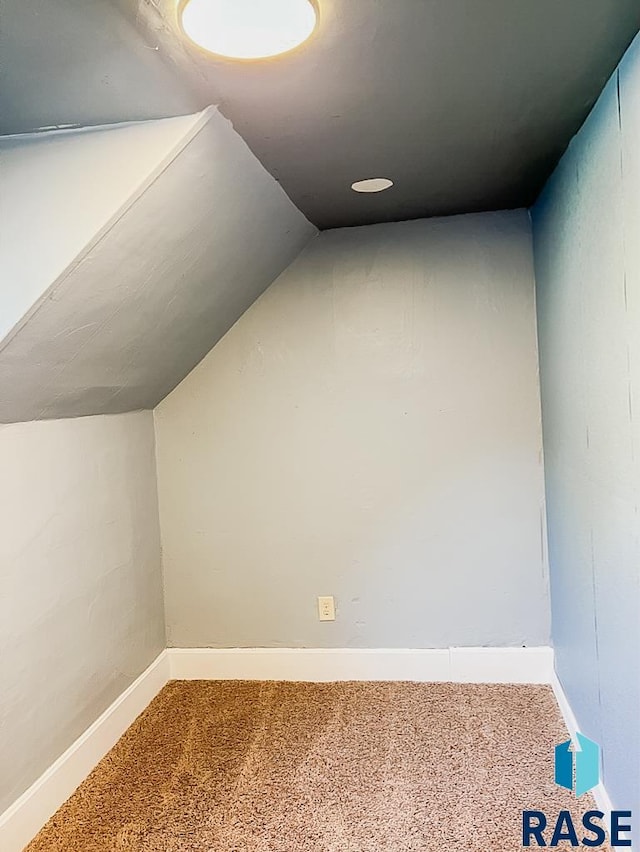 323 W Lincoln St, Luverne, MN 56156 - bonus room featuring carpet, vaulted ceiling, and baseboards