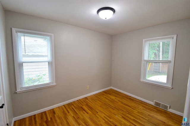 spare room with hardwood / wood-style flooring