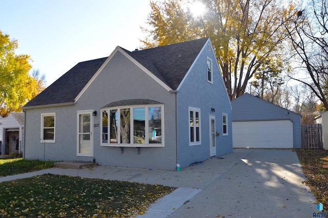 view of front facade featuring a garage and an outbuilding