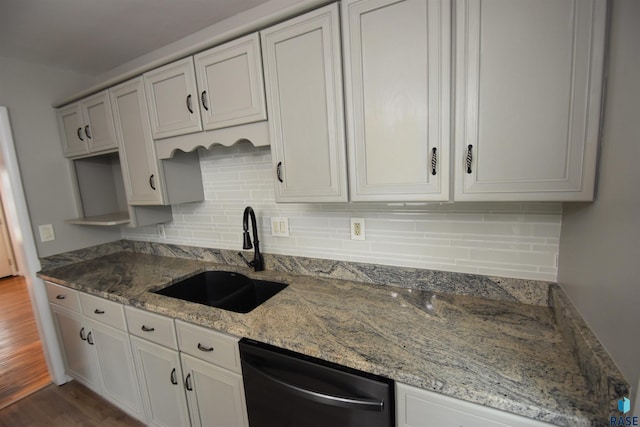 kitchen featuring stainless steel dishwasher, white cabinetry, sink, and dark hardwood / wood-style flooring