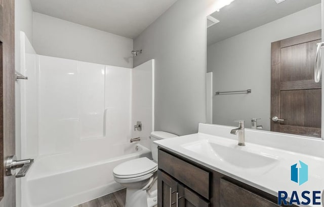 full bathroom with wood-type flooring, toilet, vanity, and bathtub / shower combination