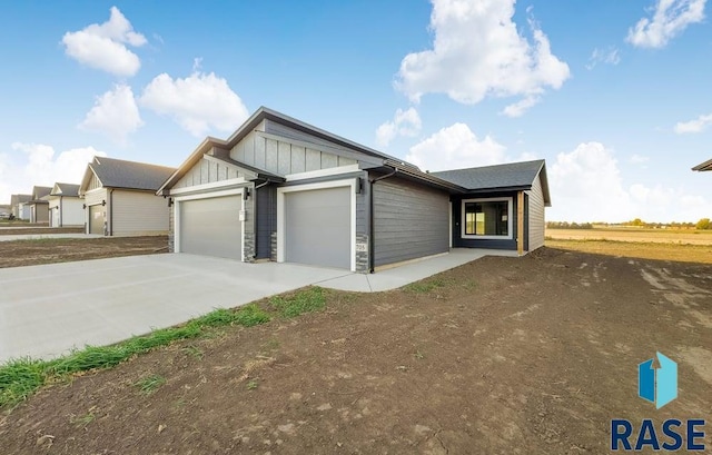 705 Sarah C St, Garretson, SD 57030 - view of front facade featuring board and batten siding, driveway, and a garage