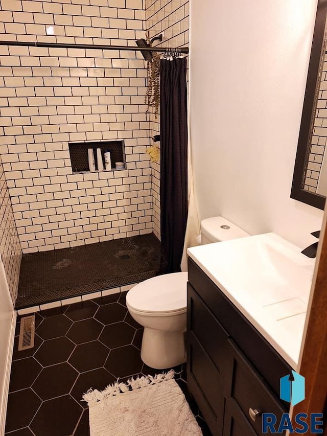 bathroom with toilet, tile patterned flooring, vanity, and a shower with shower curtain