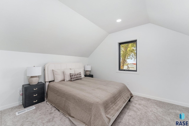 carpeted bedroom with vaulted ceiling