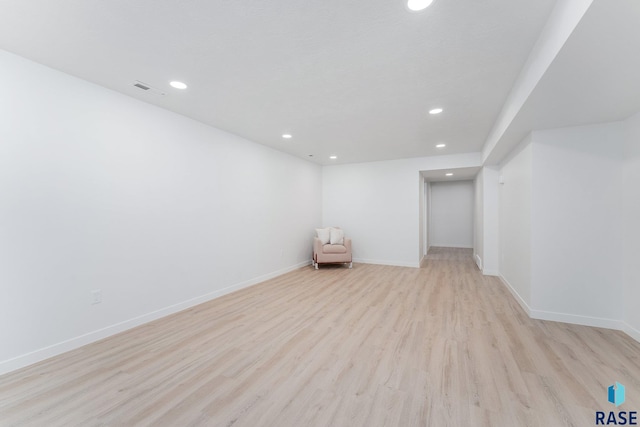 basement with light hardwood / wood-style floors