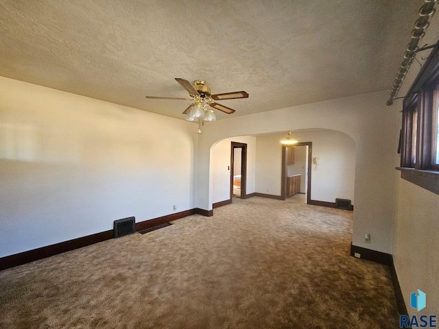 spare room featuring carpet flooring, a textured ceiling, and ceiling fan