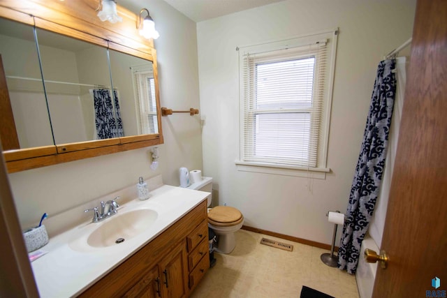 bathroom featuring walk in shower, vanity, and toilet