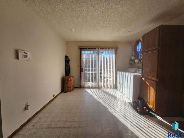 interior space featuring washer and dryer and a textured ceiling