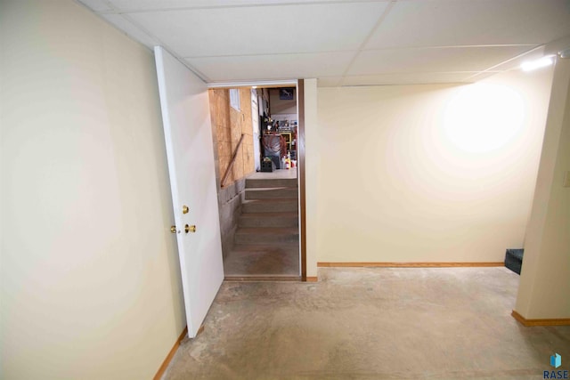 interior space with a paneled ceiling