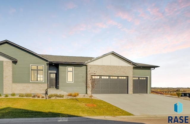 view of front of home with a garage and a yard