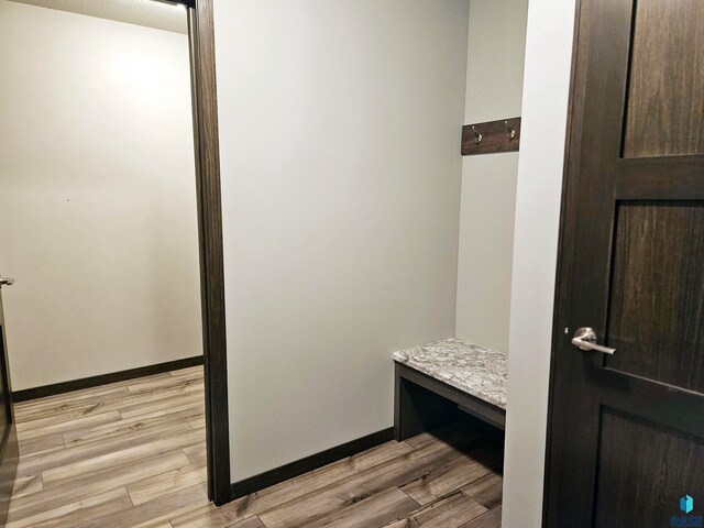 mudroom with light hardwood / wood-style floors